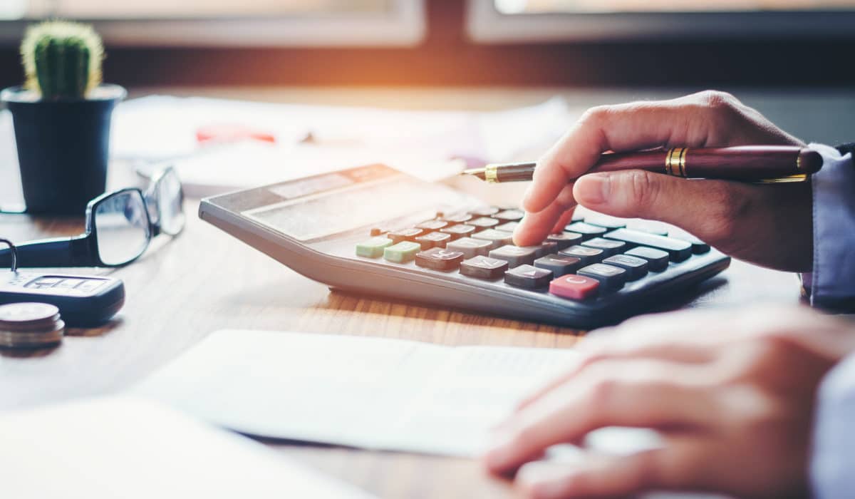Fulfillment Costs Person is calculating fulfillment costs with a calculator