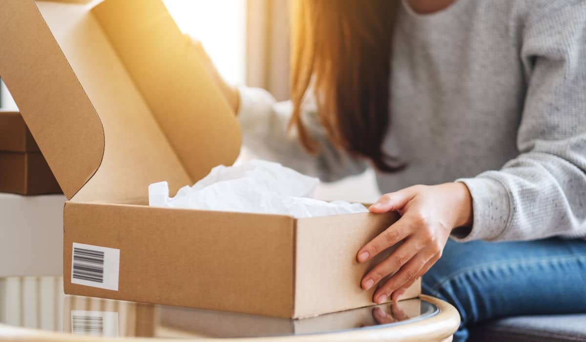 Woman opening a parcel