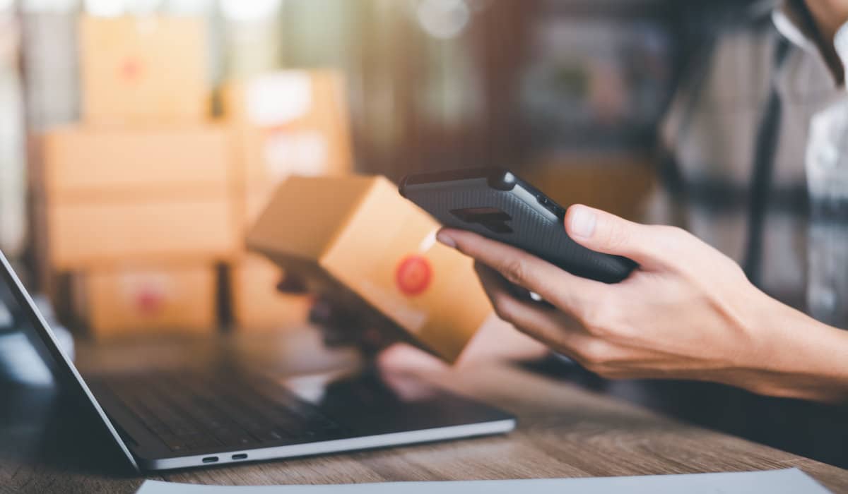 Post Purchase Experience Tips Person looks at a smartphone